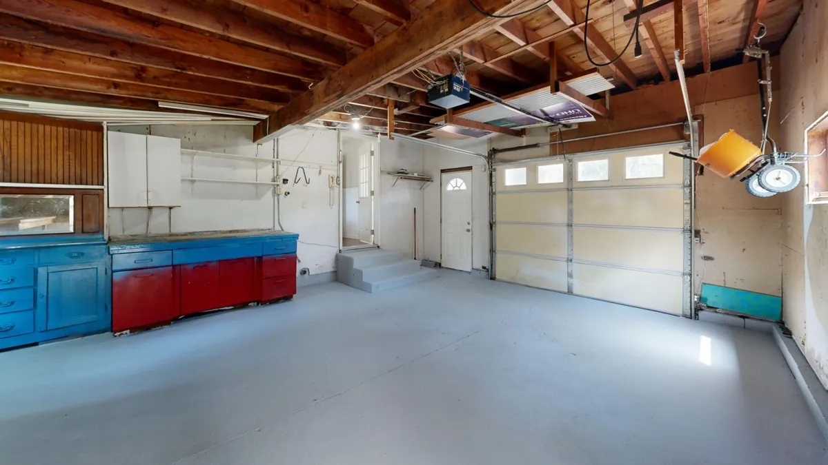 Spacious garage with storage cabinets and a gray concrete floor