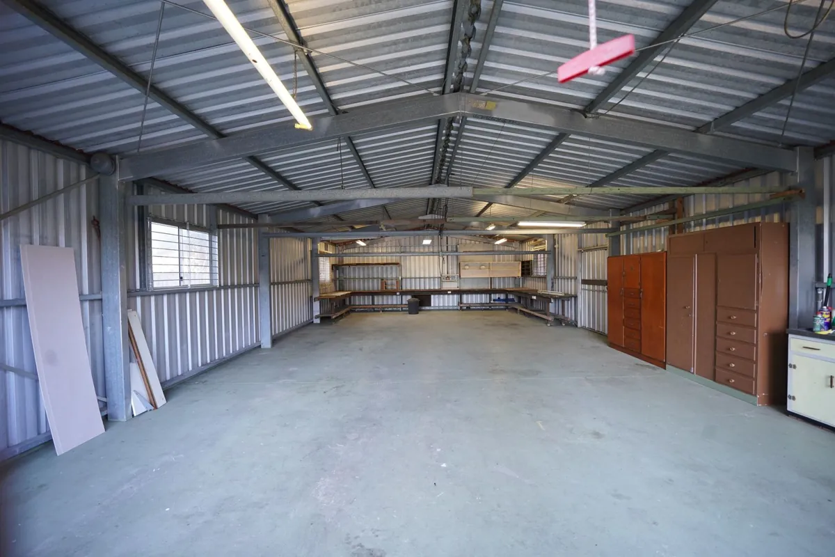 Empty metal shop building with a large concrete floor